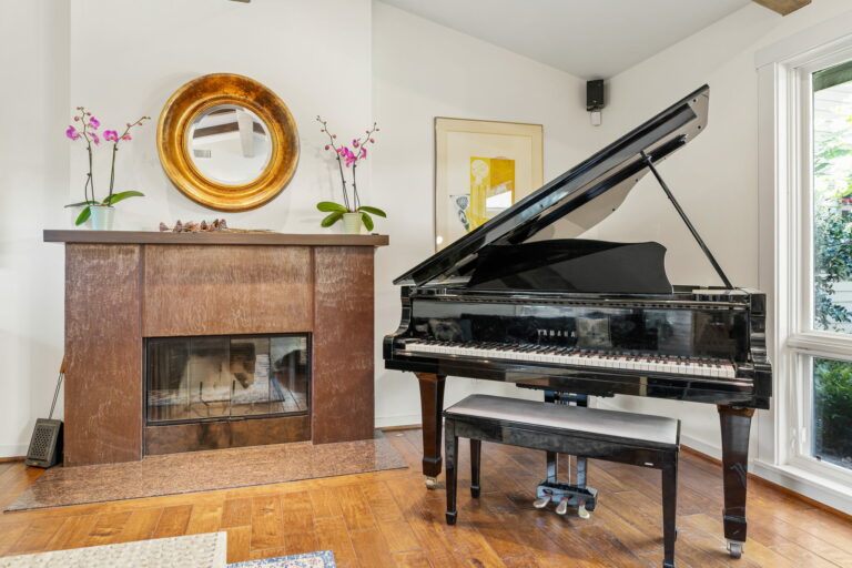 A piano in a room with a fireplace.