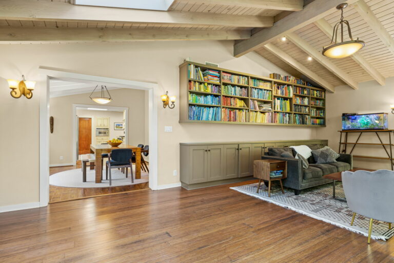 A living room with bookshelves and a tv.