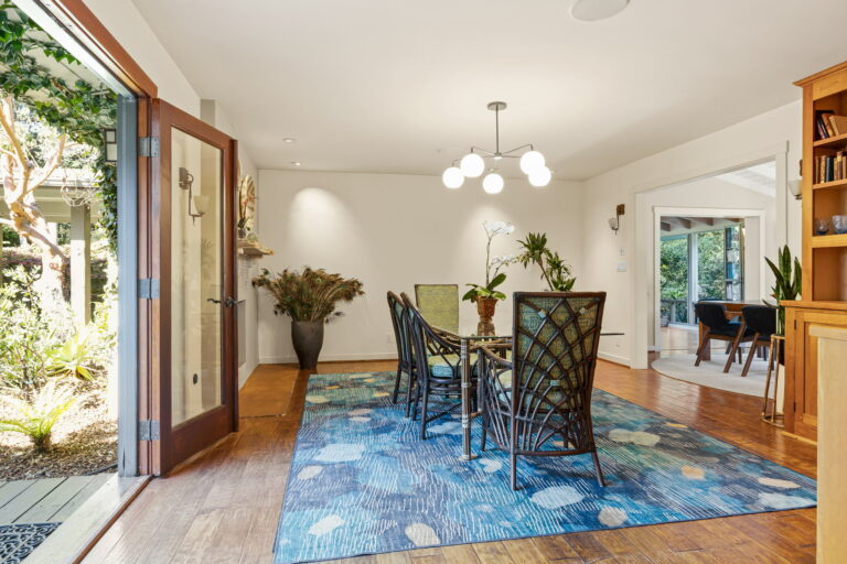 A blue rug in a dining room.