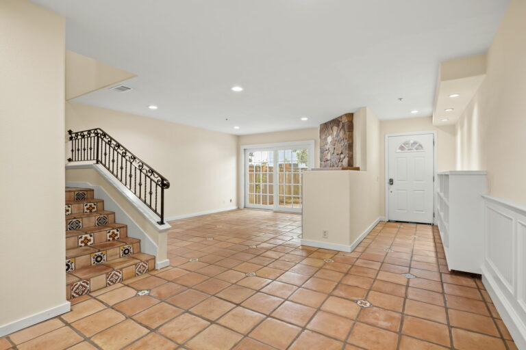 An entryway with tile floors and a staircase.