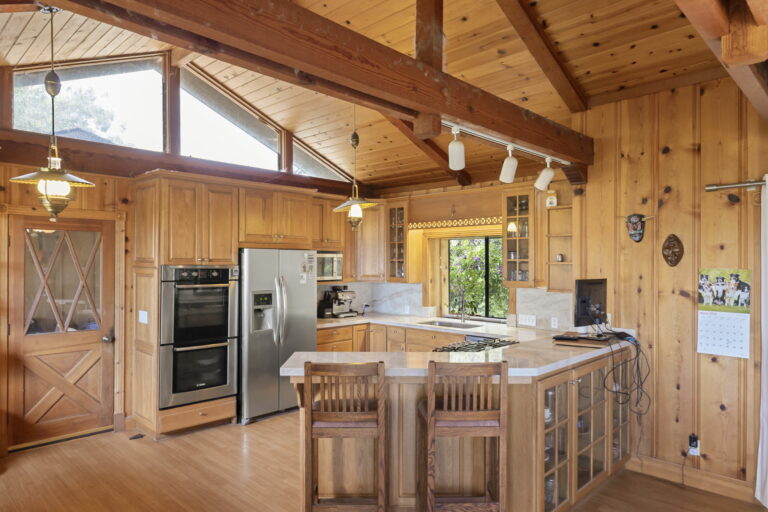 A kitchen with wooden walls.