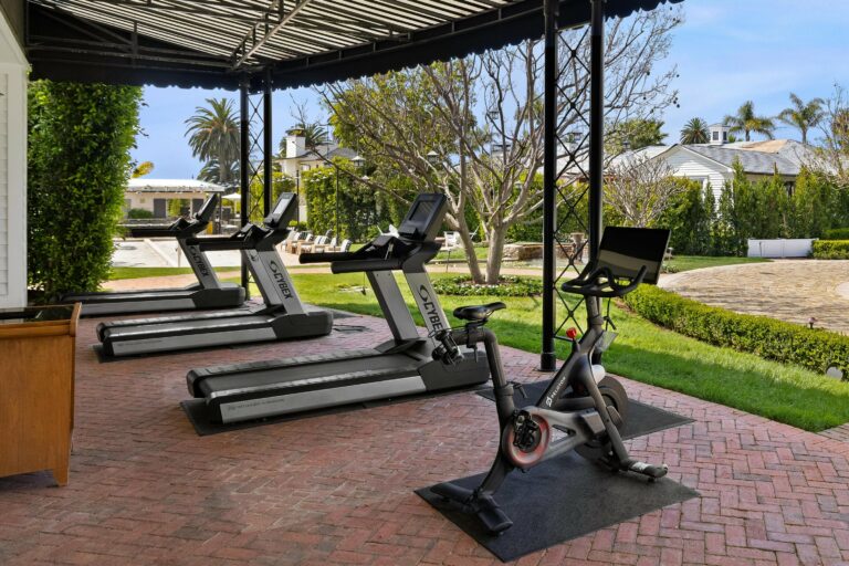 A home gym with tread machines and a gazebo.